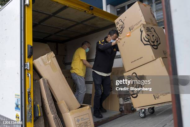 Asia Tigers Group employees transfer boxes from a truck into a shipping container, during a customer's relocation overseas, in Hong Kong, China, on...