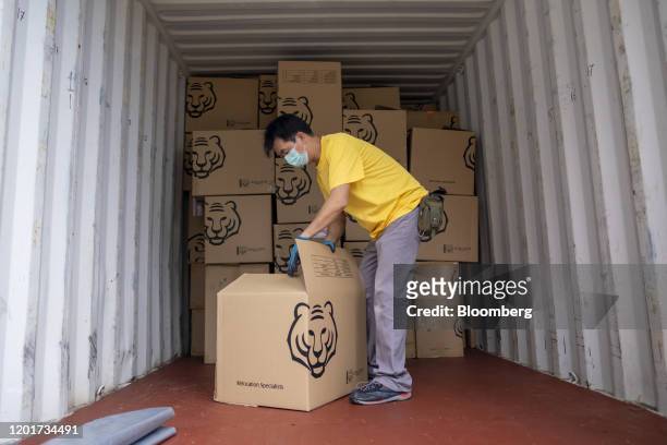 An Asia Tigers Group employee create a cardboard box inside a shipping container, during a customer's relocation overseas, in Hong Kong, China, on...