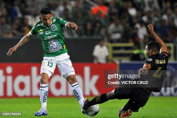 Mexico's Leon Angel Mena vies for the ball with US LAFC Eddie Segura during the first leg quarterfinal football match of the Concacaf Champions...