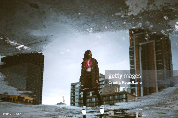 woman in overcast downtown seattle washington - puddle reflection stock pictures, royalty-free photos & images