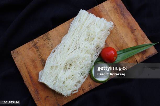 vermicelli on a wooden cutting board - vermicelli stock pictures, royalty-free photos & images