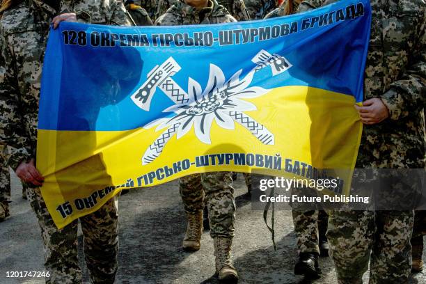 Flag of the 128th independent mountain assault brigade that maintained the defence of the Debaltseve base area is seen during the requiem march,...