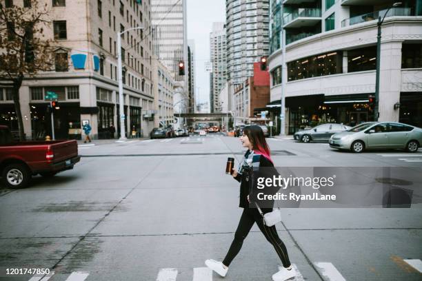 woman in overcast downtown seattle washington - seattle city life stock pictures, royalty-free photos & images