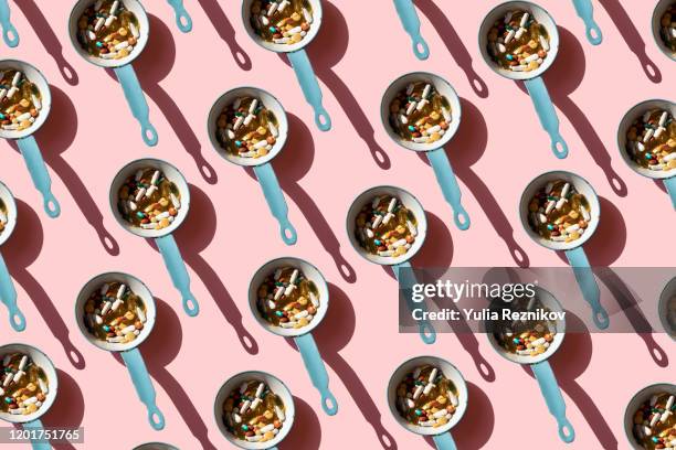 top view of pan full of various pills and tablets on the blue background - vitamin a stock pictures, royalty-free photos & images