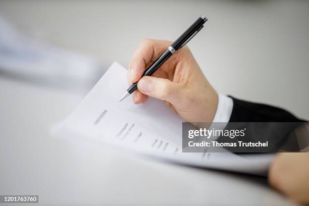 Symbol photo on the subject of contract conclusion. A man signs a contract with a pen on February 18, 2020 in Berlin, Germany.