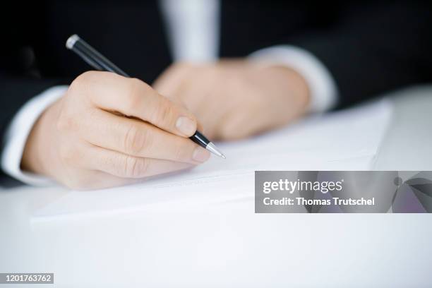 Symbol photo on the subject of contract conclusion. A man signs a contract with a pen on February 18, 2020 in Berlin, Germany.