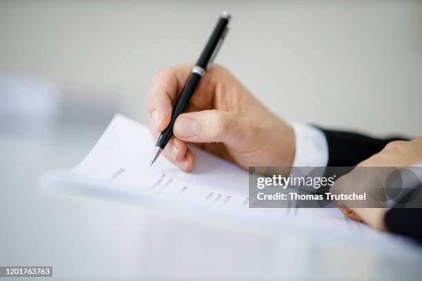 Symbol photo on the subject of contract conclusion. A man signs a contract with a pen on February 18, 2020 in Berlin, Germany.