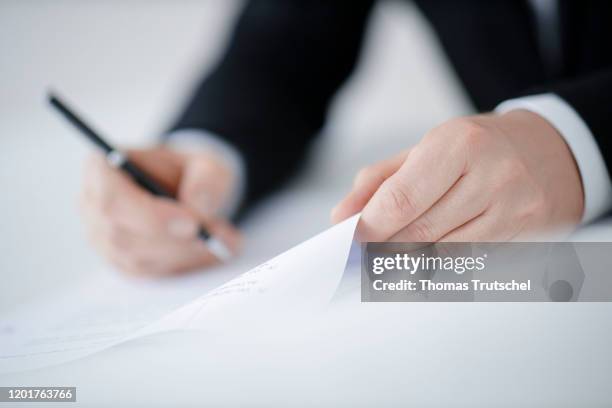 Symbol photo on the subject of contract conclusion. A man signs a contract with a pen on February 18, 2020 in Berlin, Germany.