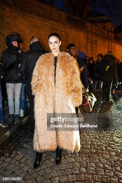 Fiona Zanetti wears a brown winter fluffy faux fur coat, outside Valentino, during Paris Fashion Week - Haute Couture Spring/Summer 2020, on January...