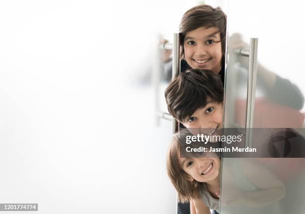 group of boys behind glass door smiling - child eyes closed stock pictures, royalty-free photos & images