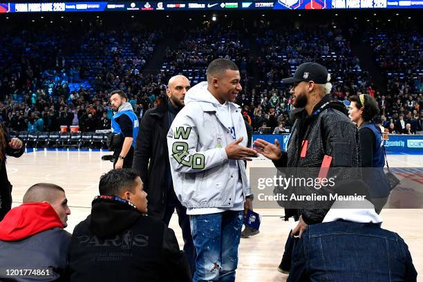 Kylian Mbappe and Neymar Jr of Paris Saint-Germain attend the NBA match between the Milwaukee Bucks and the Charlotte hornets at AccorHotels Arena on...