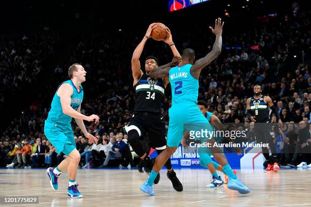 Giannis Antetokounmpo of the Milwaukee Bucks handles the ball in front of Marvin Williams of Charlotte Hornets during the NBA Paris Game match...