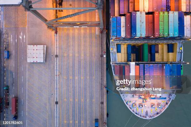 top view of international port with crane loading containers in import export business logistics. - shipyard aerial stock pictures, royalty-free photos & images
