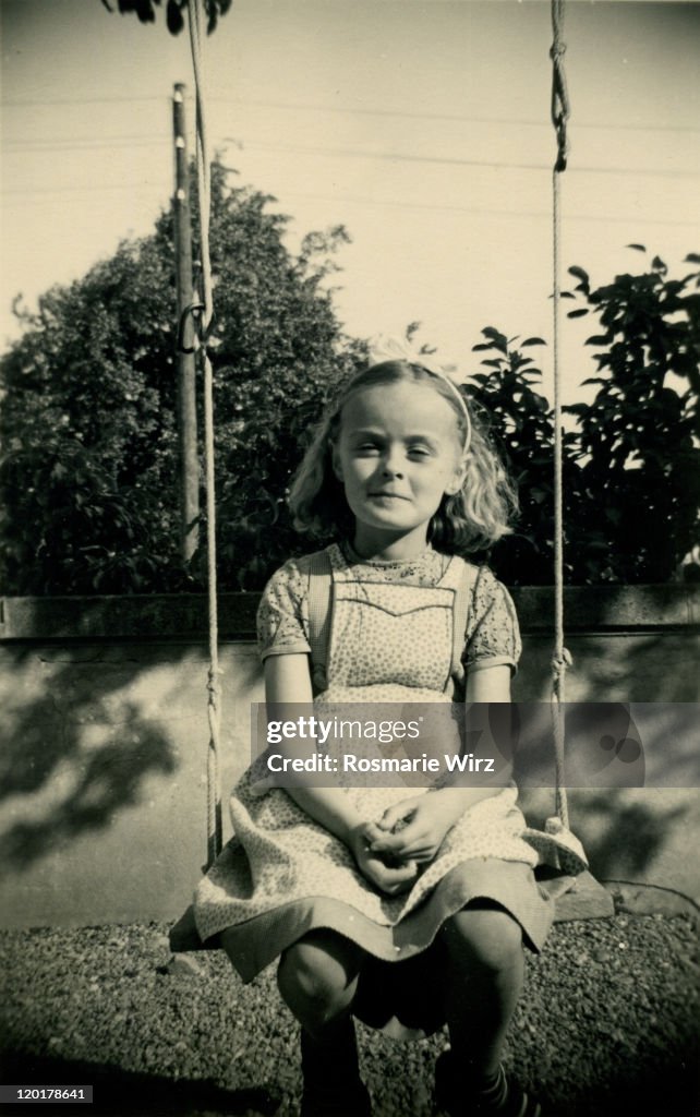 Girl sitting on swing