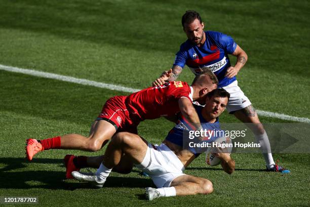 Harry Jones of Canada tackles Paulin Riva of France while Terry Bouhraoua looks on during the match between France and Canada at the 2020 HSBC Sevens...