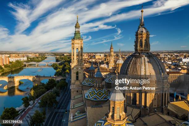 view of the roofs and spires of basilica of our lady in zaragoza, spain - ebro river stock-fotos und bilder