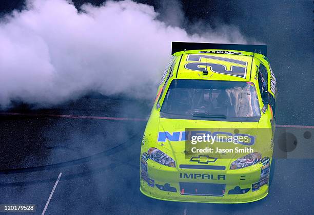 Paul Menard, driver of the NIBCO/Menards Chevrolet, celebrates with a burnout after winning the NASCAR Sprint Cup Series Brickyard 400 at...