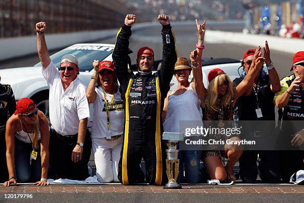 Paul Menard, driver of the NIBCO/Menards Chevrolet, celebrates on the bricks after winning the NASCAR Sprint Cup Series Brickyard 400 at Indianapolis...