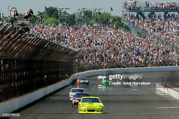 Paul Menard, driver of the NIBCO/Menards Chevrolet, takes the checkered flag as he crosses the finish line to win the NASCAR Sprint Cup Series...