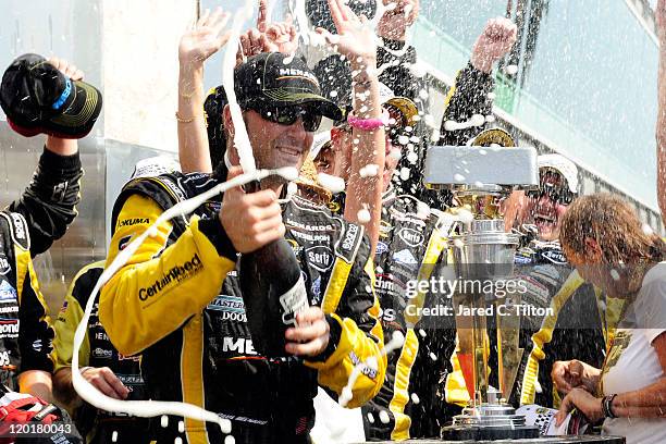 Paul Menard, driver of the NIBCO/Menards Chevrolet, celebrates in Victory Lane after winning the NASCAR Sprint Cup Series Brickyard 400 at...