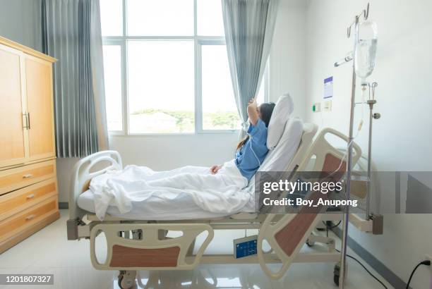 portrait of sickness patient woman lying on hospital bed, feeling sad and depressed worried. - teenager headache stock pictures, royalty-free photos & images