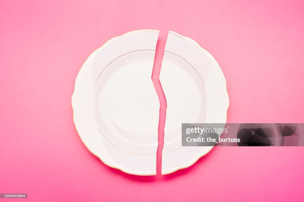Broken plate on pink background