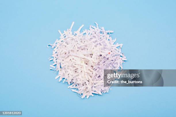 shredded paper on blue background - em tiras imagens e fotografias de stock