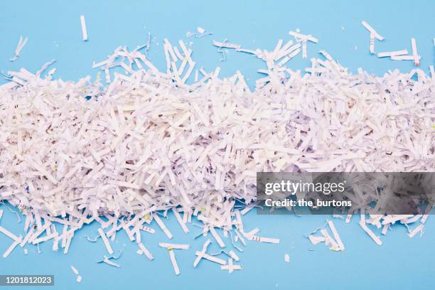 shredded paper on blue background - em tiras imagens e fotografias de stock