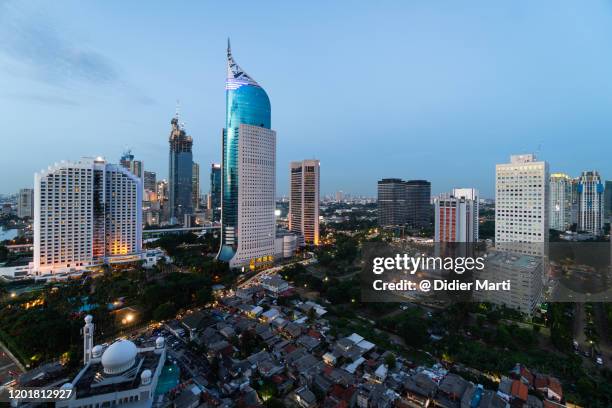 nightfall over jakarta downtown business district in indonesia capital city - 新興国 ストックフォトと画像