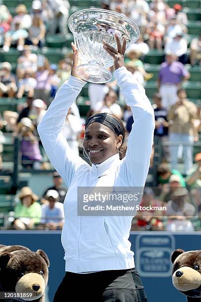 Serena Williams poses for photographers after her win over Marion Bartoli of France during the final of the Bank of the West Classic at the Taube...