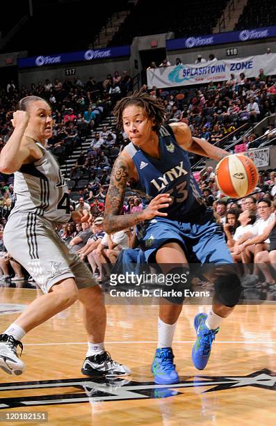 Seimone Augustus of the Minnesota Lynx drives against Tully Bevilaqua of the San Antonio Silver Stars at the AT&T Center on July 31, 2011 in San...