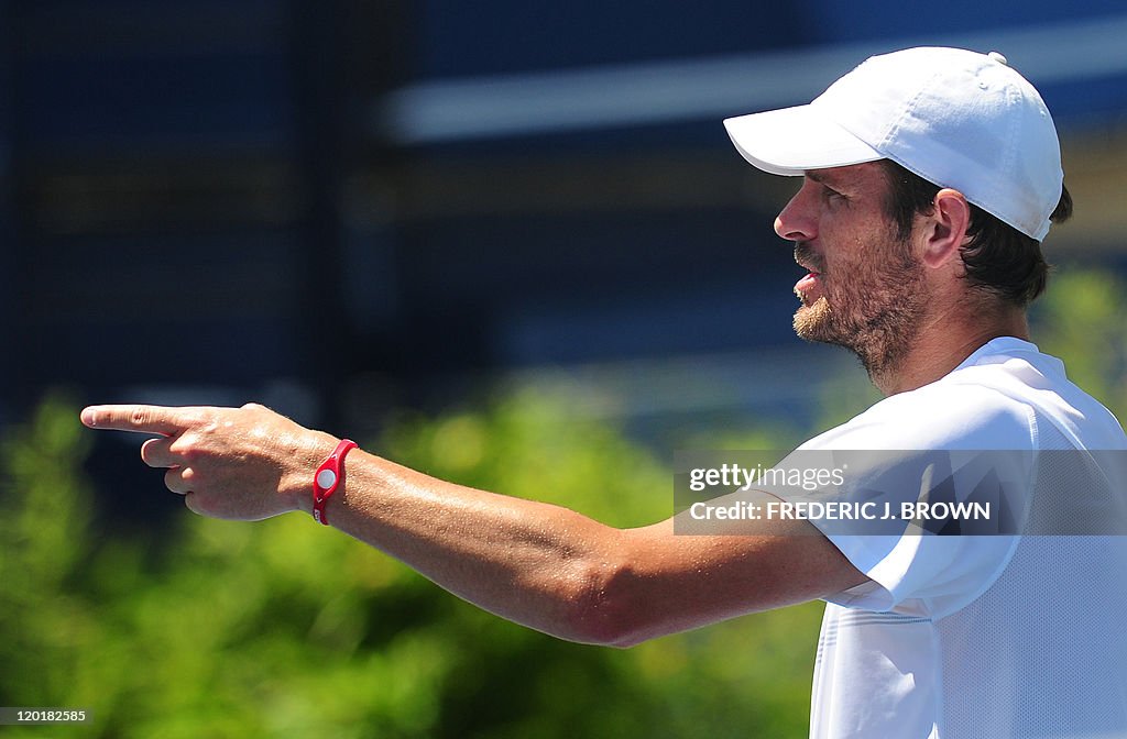 Mardy Fish of the US questions the umpir