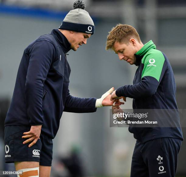 Dublin , Ireland - 19 February 2020; Jonathan Sexton has his fingers strapped by physio Colm Fuller during Ireland Rugby squad training at IRFU High...