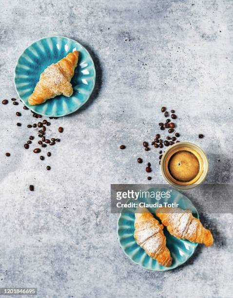 a cup of coffee and croissants on gray background - croissant café stock-fotos und bilder