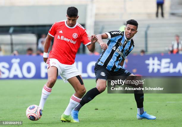 Leonardo of Internacional and Rildo of Gremio fisght for the ball controls the ball during the match between Internacional and Gremio for the Copa...