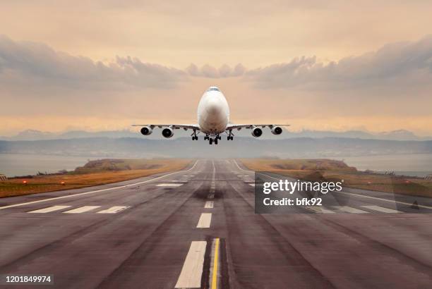 a large cargo airplane taking off. - plane landing stock pictures, royalty-free photos & images