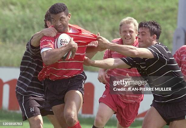 Le trois-quart-centre international toulousain Emile Ntamack, se fait prendre par l'ailier Xavier Garbajosa , sous le regard du trois-quart- centre...