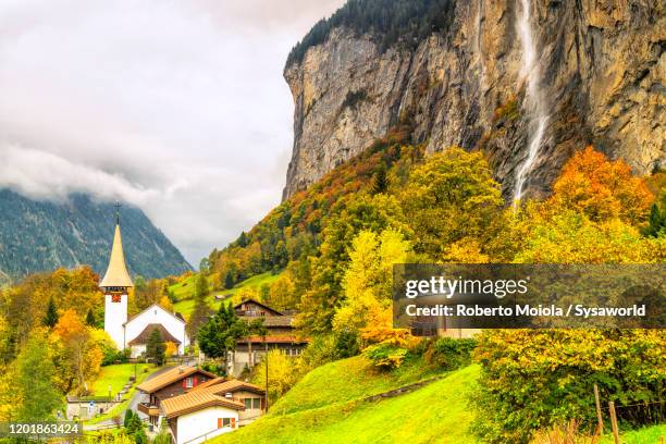 lauterbrunnen village and waterfall in autumn, switzerland - interlaken ストックフォトと画像