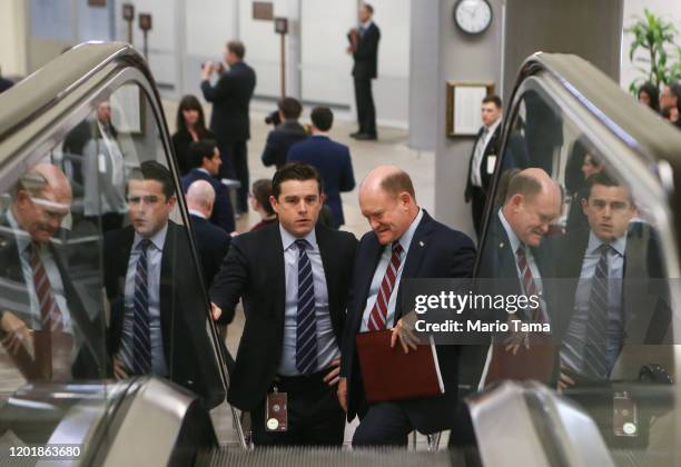 Sen. Chris Coons , RIGHT C, takes an escalator on his way to the U.S. Capitol from the Senate subway for impeachment trial proceedings against...