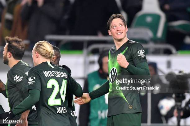 Wout Weghorst of VfL Wolfsburg celebrates after Admir Mehmedi scores his team's first goal during the Bundesliga match between VfL Wolfsburg and...