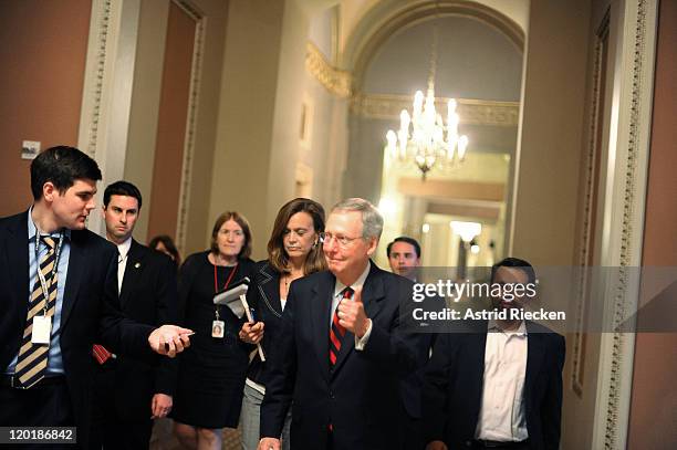 Senate Minority Leader Sen. Mitch McConnell gives a thumbs up when asked whether a deal has been reached regarding the ongoing debate on the national...