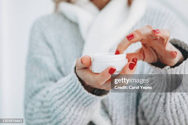 female hand with hand cream - applying cream stock pictures, royalty-free photos & images