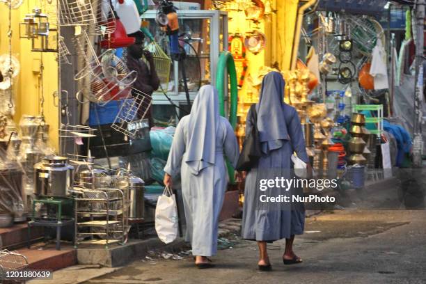 Nuns walk along a street in the Chalai Market in Thiruvananthapuram , Kerala, India.