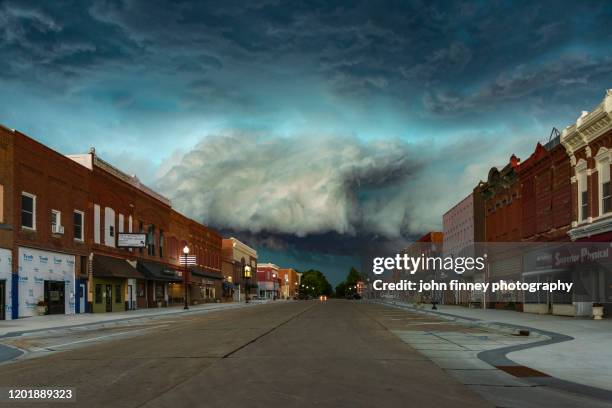 supercell storm approaches an almost deserted town of superior in nebraska. usa - town square america stock pictures, royalty-free photos & images