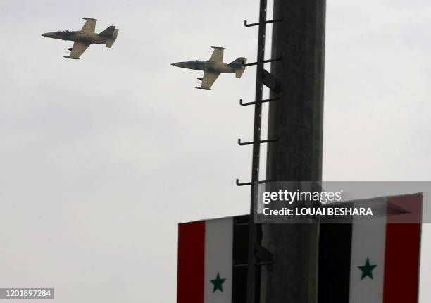 Syrian military aircrafts fly by after accompanying the airplane which took the first flight from the capital Damascus to Aleppo's airport on...