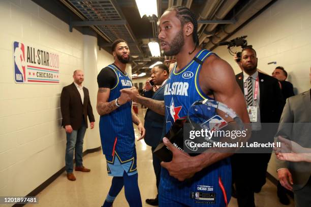 Anthony Davis of Team LeBron congratulates Kawhi Leonard after he receives the Kobe Bryant MVP award during the NBA All-Star Game as part of 2020 NBA...