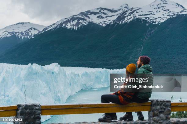 couple looking at scenic view of perito moreno glacier in patagonia - santa cruz province argentina stock pictures, royalty-free photos & images