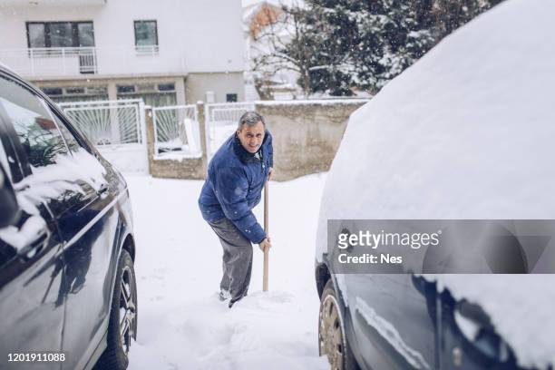mann hat ein problem mit schnee, winterwetter - snow shovel stock-fotos und bilder