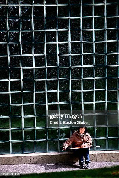 At Harvard University, Winifred Wang, an architectural student from Harvard, does some of her school work seated by some windows on campus at Quincy...