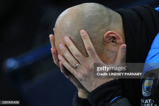 Manchester City's Spanish manager Pep Guardiola holds his head in his hands ahead of the English Premier League football match between Manchester...